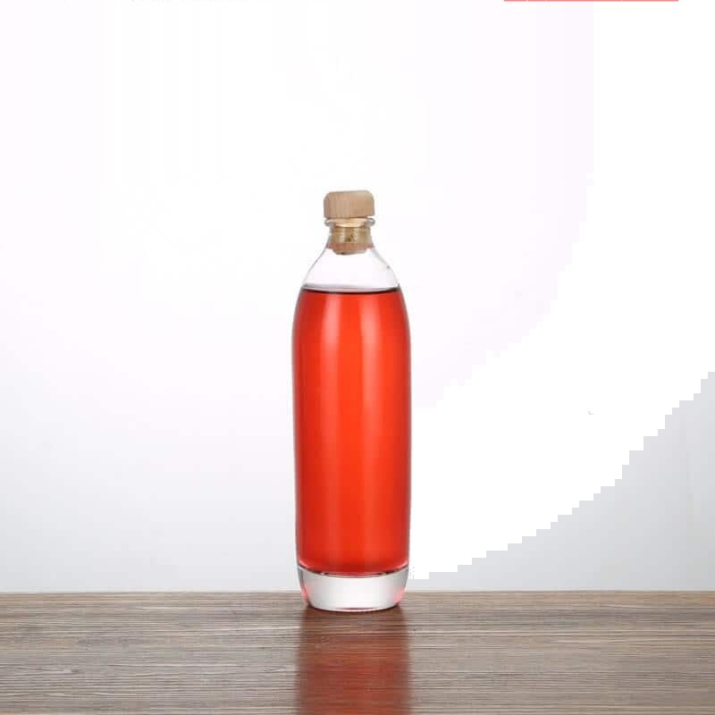 Round liquor bottle, 500 ml, filled with a rose-coloured spirit